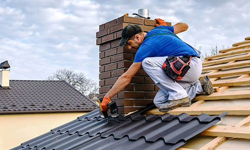 Angelman Roofing and Restoration worker working on roof